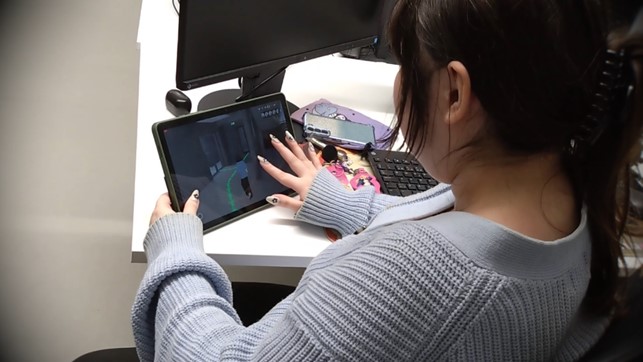 Person holding and using a tablet.